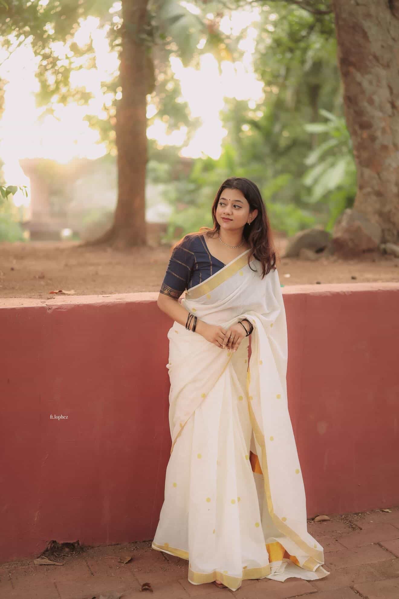 Kerala Kasavu saree in polka dots paired with navy blue Sungudi blouse