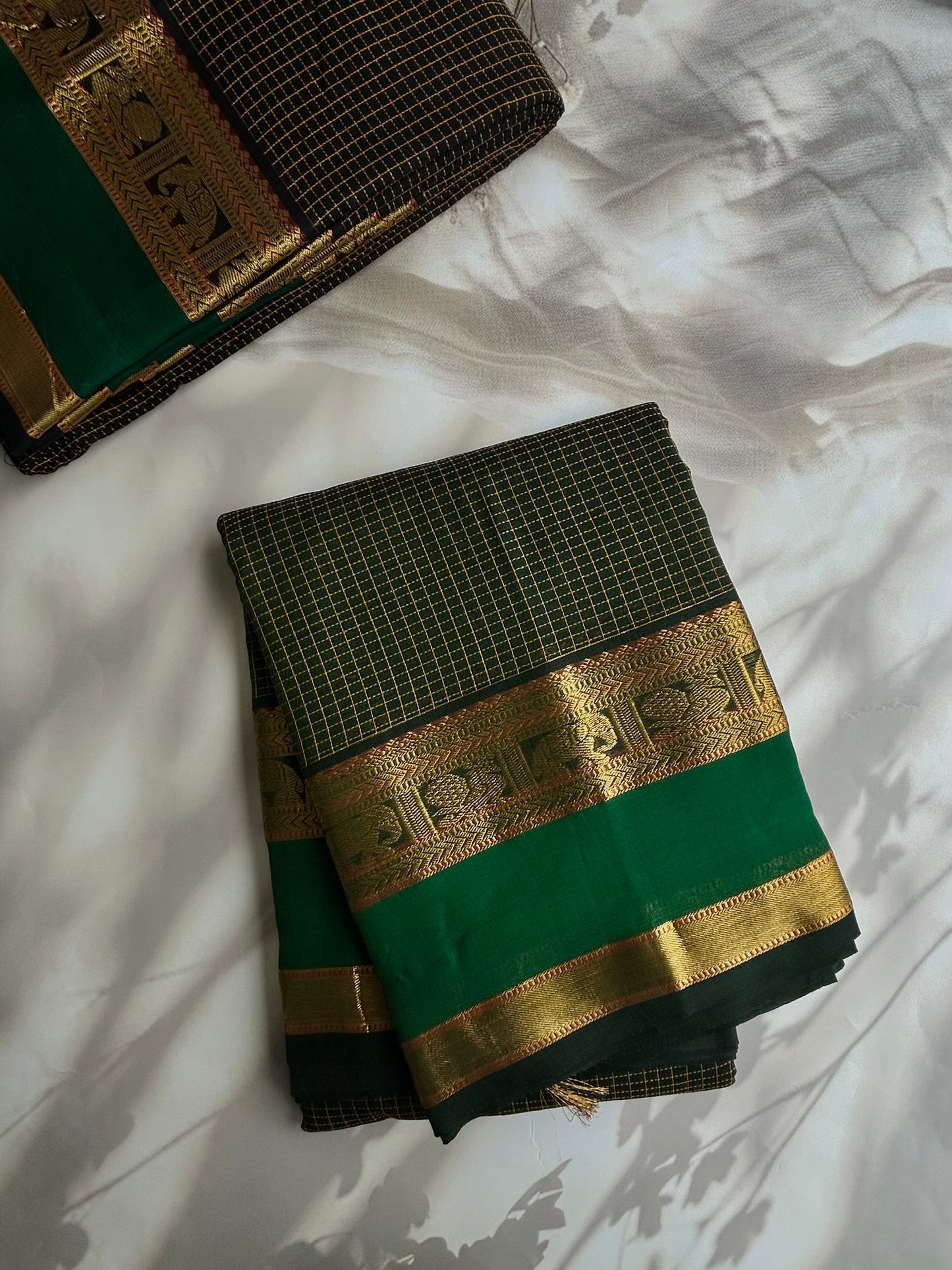 120 mercerised Kanchi cotton with checks on green base with grand pallu