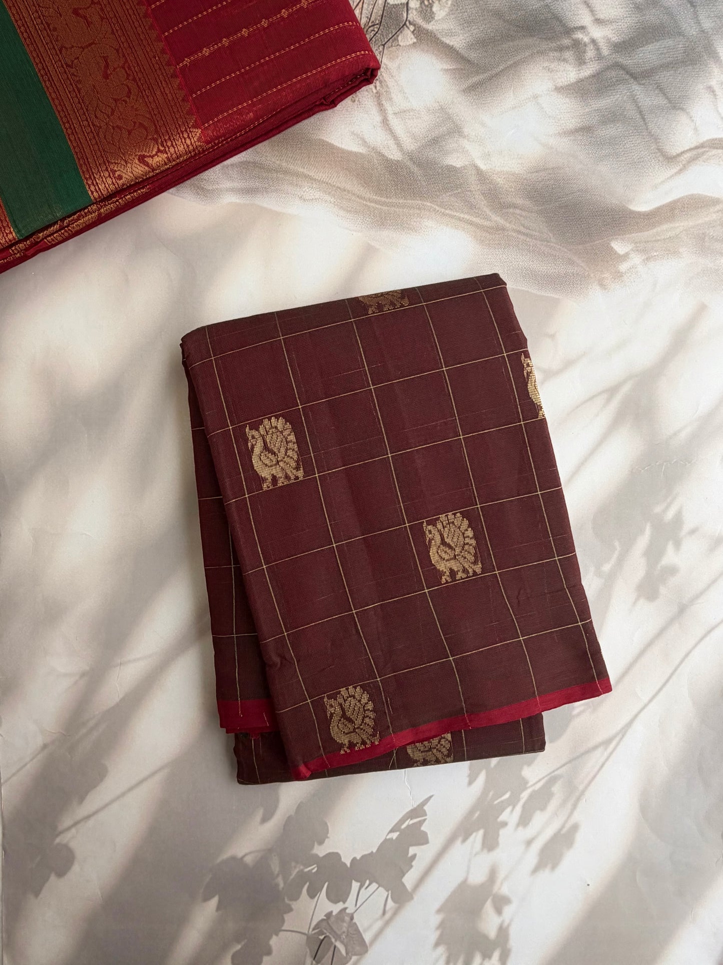 Kanchi cotton saree with checks & peacock zari weaves with a grand pallu