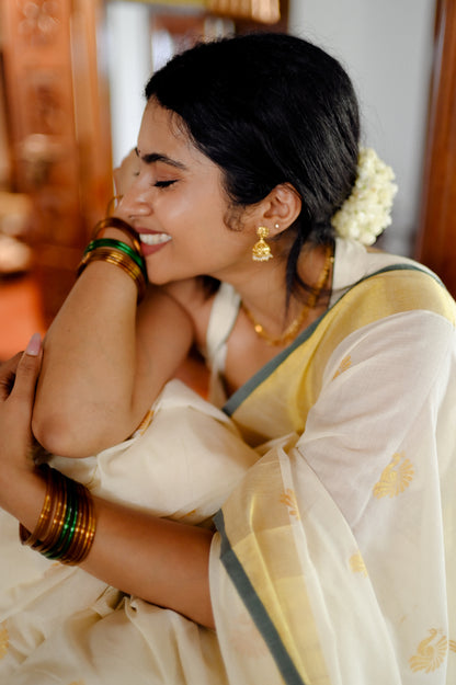 Kasavu saree in peacock print with green border