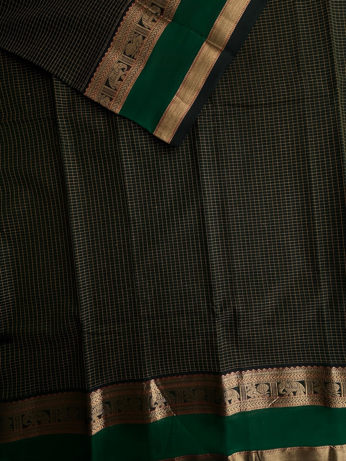 120 mercerised Kanchi cotton with checks on green base with grand pallu