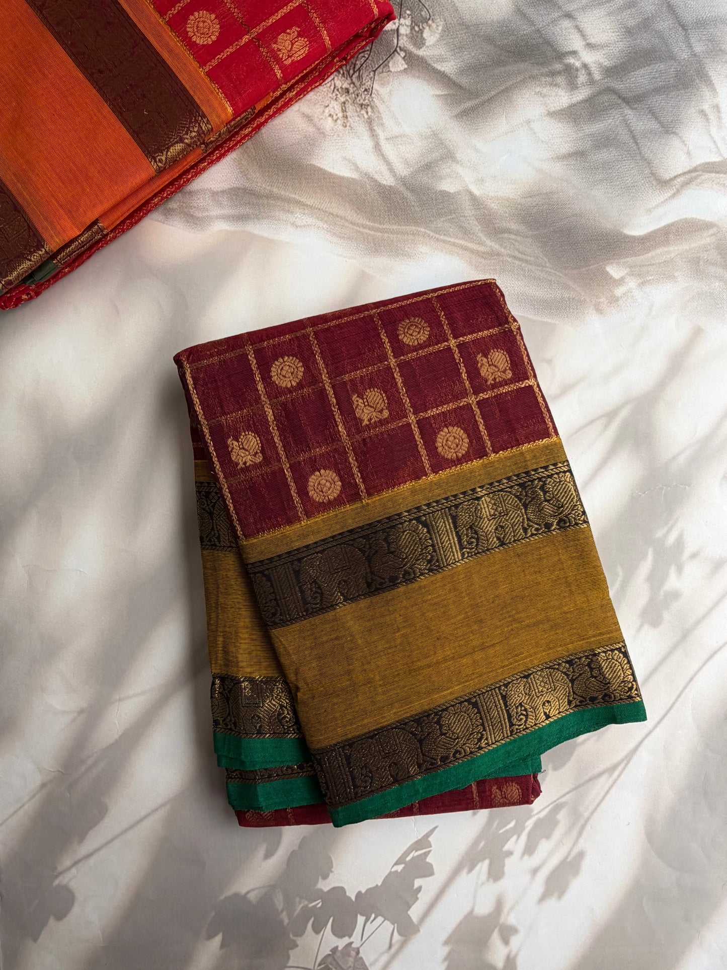 Kanchi cotton saree in zari check & butta weaves in with a grand pallu maroon