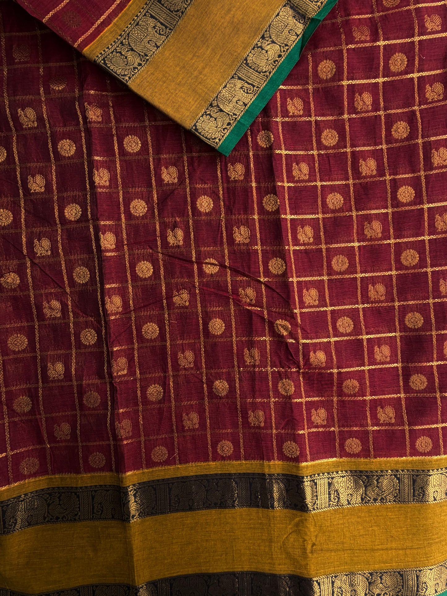 Kanchi cotton saree in zari check & butta weaves in with a grand pallu maroon