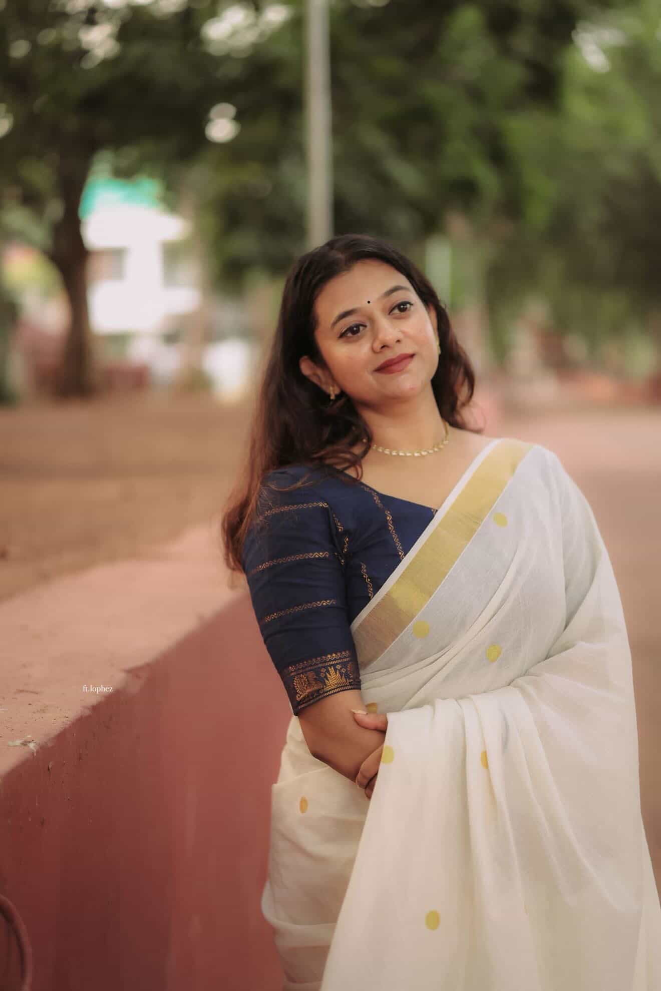 Kerala Kasavu saree in polka dots paired with navy blue Sungudi blouse