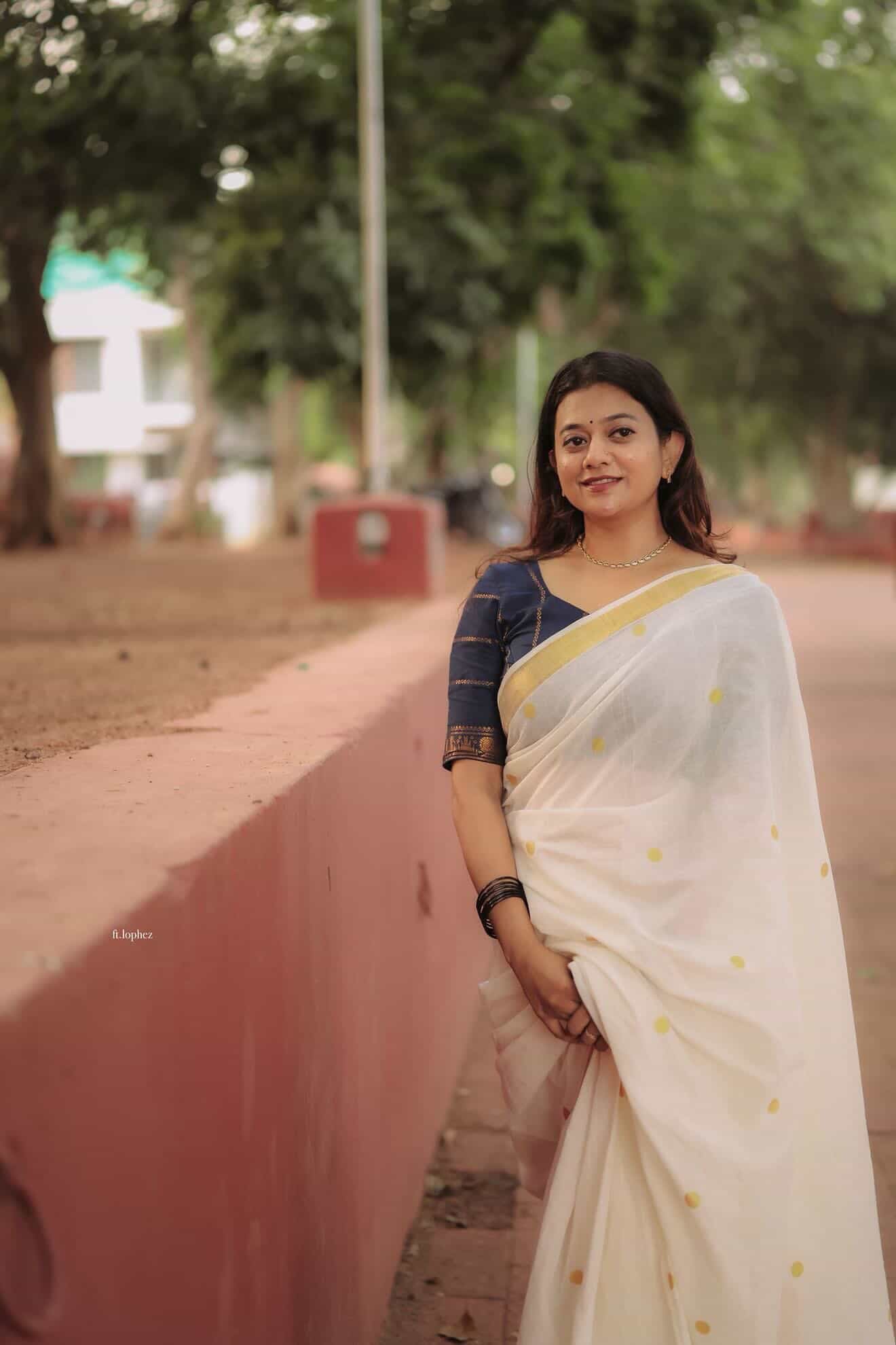 Kerala Kasavu saree in polka dots paired with navy blue Sungudi blouse