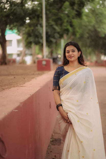 Kerala Kasavu saree in polka dots paired with navy blue Sungudi blouse