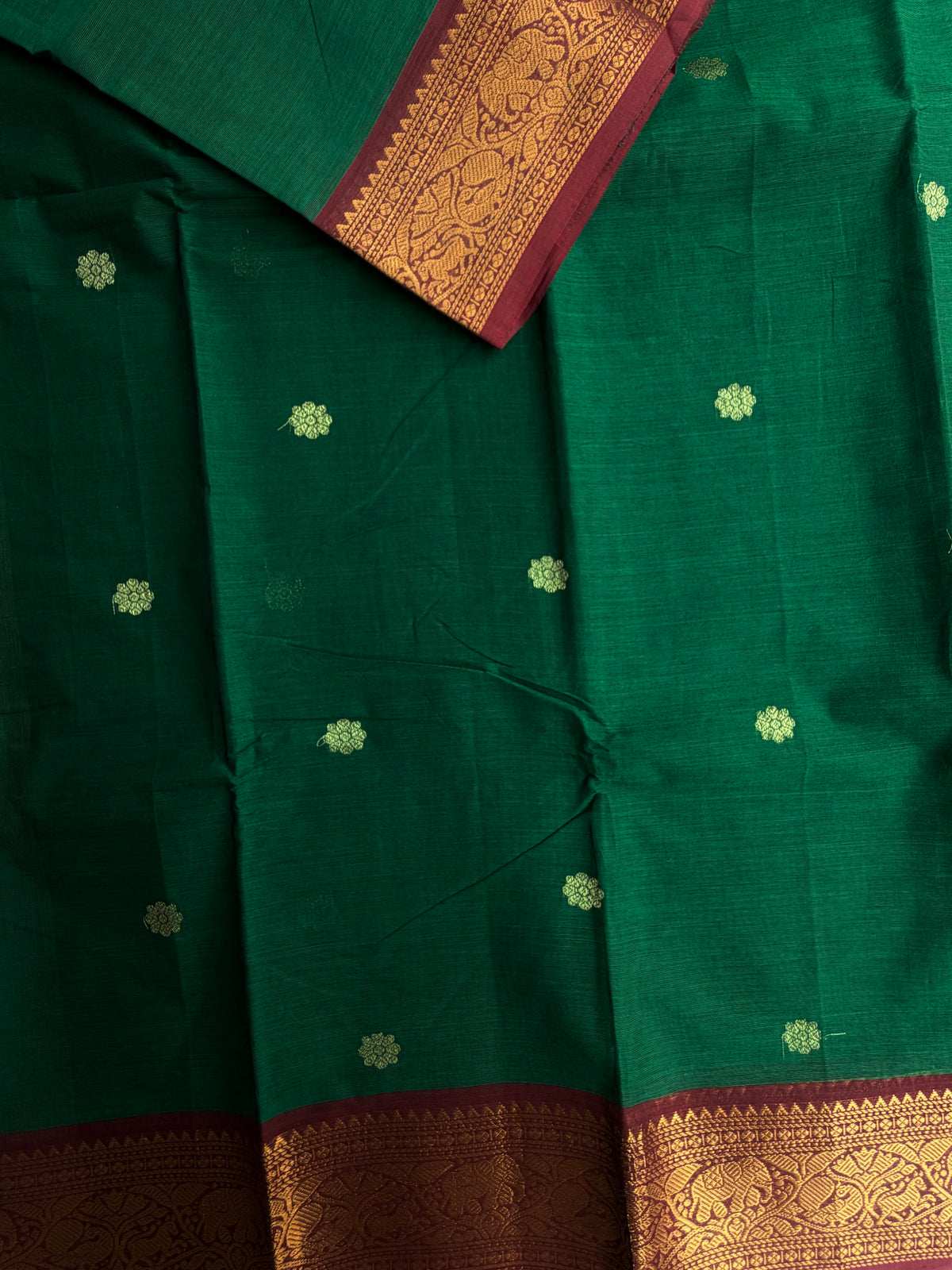 Kanchi cotton saree with butta weaves & grand pallu dark green