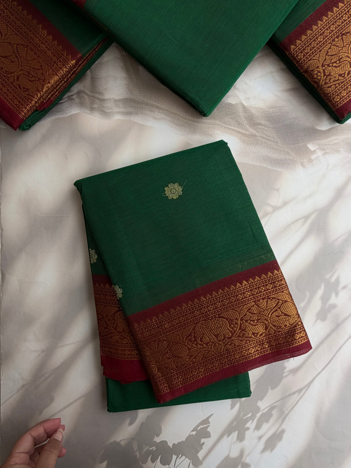 Kanchi cotton saree with butta weaves & grand pallu dark green