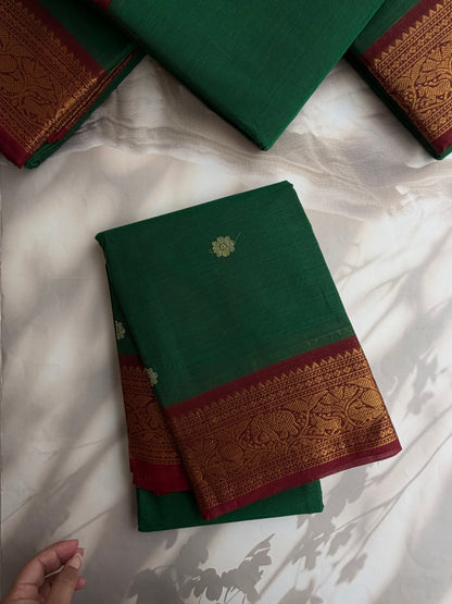 Kanchi cotton saree with butta weaves & grand pallu dark green