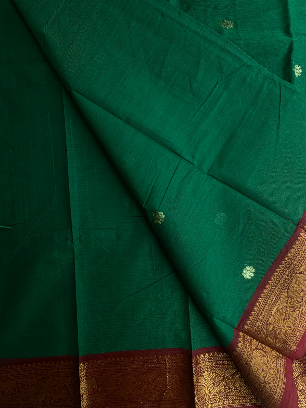 Kanchi cotton saree with butta weaves & grand pallu dark green